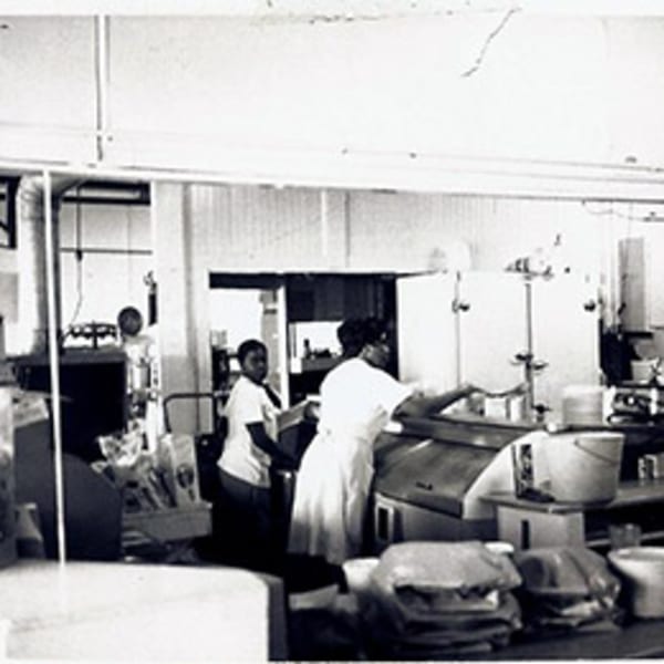 Black and white photo of three women working in a busy diner kitchen at Lovick's Cafe.