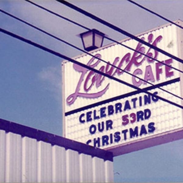 Lovick's Cafe sign, celebrating "Our 53rd Christmas," with power lines crossing the frame.
